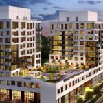Arial view of Gemini Condos at dusk with its rooftop terrace lit up.